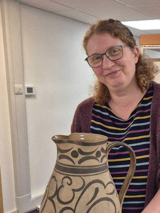 Liz examining items from the Poole Pottery collection