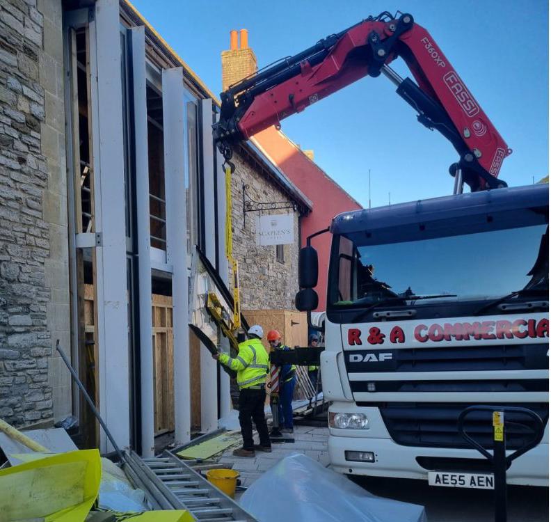 Scaplen's window being installed with heavy machinery