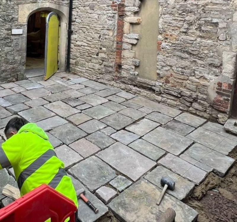 The paving stones being placed back in Scaplen's courtyard