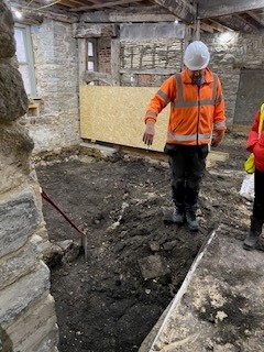 Inspecting floor in Scaplen's Court, Poole Museum